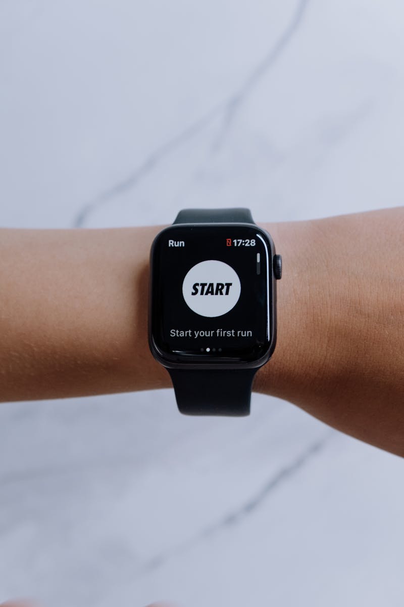 Smartwatch displaying a running app interface with 'Start your first run' prompt on screen